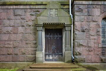 Vintage door handles. Old wooden front door with antique handle.