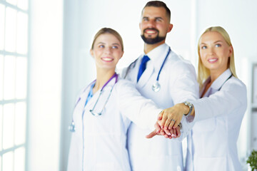 Fototapeta premium Doctors and nurses coordinate hands. Concept Teamwork in hospital for success work and trust in team.