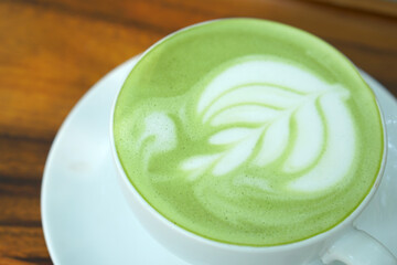 Hot green tea. Flower bubbles in a glass.