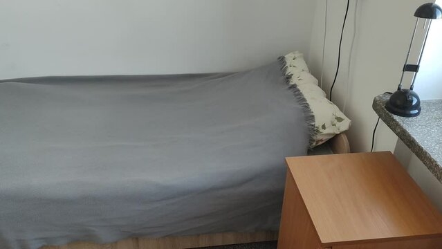 Bed in a student room. Room in a student dormitory