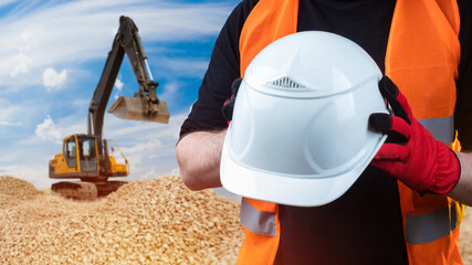 Excavator driver. White helmet in hands of man. Framed builder. Excavator at stone quarry. Concept...