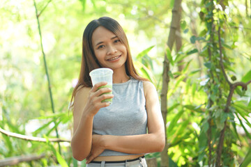 Woman drinking iced green tea in coffee cafe