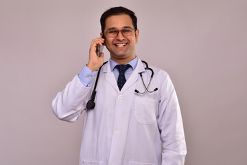 Young Indian Male Doctor talking on cell phone