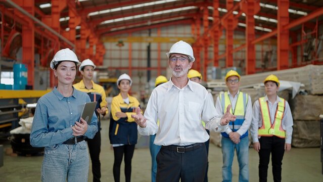Manager leader talking with camera for presentation the project and introduce team of factory workers to partner at factory 