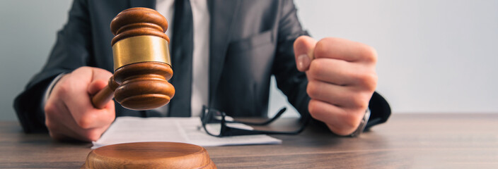 Male judge in a courtroom with the gavel