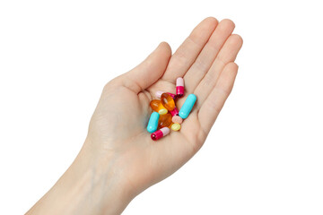 Hand holding a variety of pills on white background. Vitamins isolated on white background.