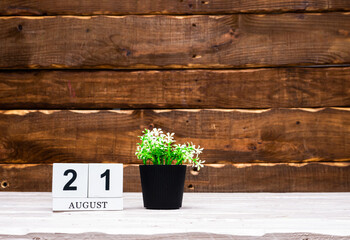 August calendar with number  21. Planner copy space on a wooden brown background. March number icon. Place for text background calendar