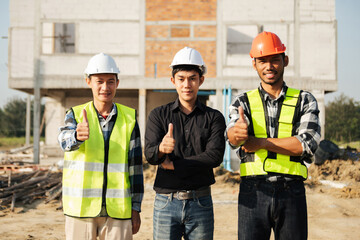 Architect caucasian man working with colleagues mixed race in the construction site. Architecture engineering on big project. Building in construction  interior.