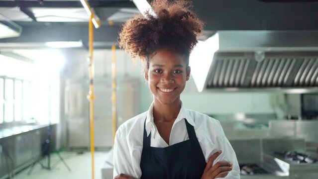 Happy cheerful junior Asian chef showing a beautiful smile to camera while in kitchen.