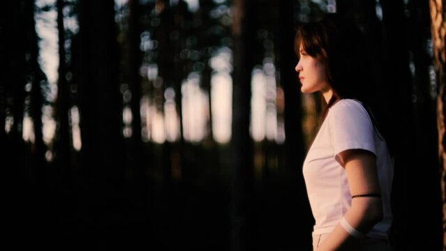 lonely beautiful woman walks through the forest and is sad. The concept of existential crisis and walks in nature.
