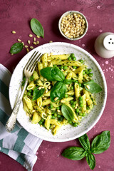 Spring pasta penne with basil pesto and sweet pea. Top view with copy space.