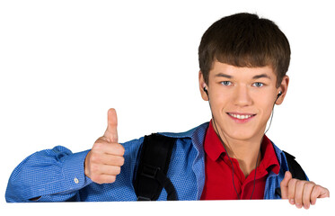 Teen male preppy with headphones giving thumbs up behind invisible sign