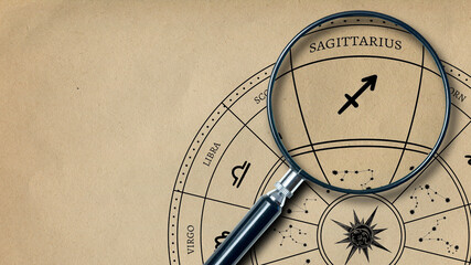 The imprint of the zodiac sign on Sagittarius old paper is enlarged with a lens