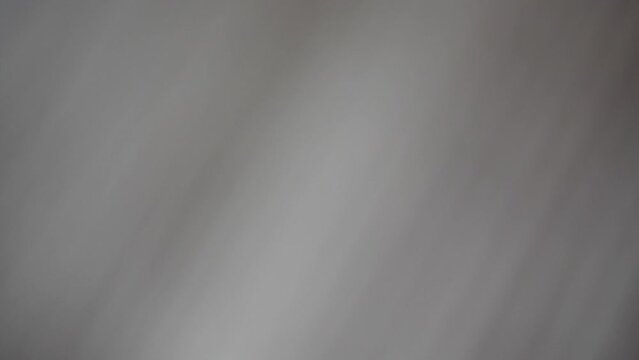 Moving light projection on white wall background, abstract parallel gradient line pattern of sun ray alternate with shadow, stream of beam shining in a gloomy room.