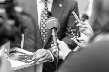 Digital voice recorder and microphone in focus, news or press conference or media interview