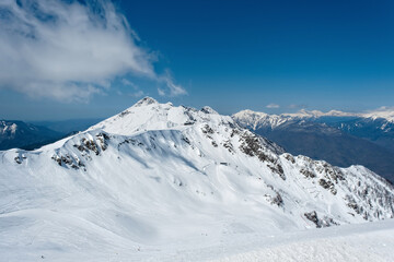 Beautiful snow capped peaks of the Caucasus Mountains. Rosa Khutor Alpine Resort in Sochi. Russia