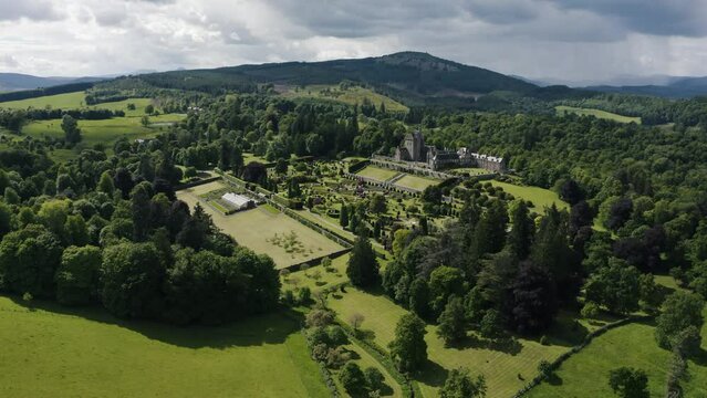 Wide drone shot of Drummond Castle Gardens in Scotland's beautiful green countryside.