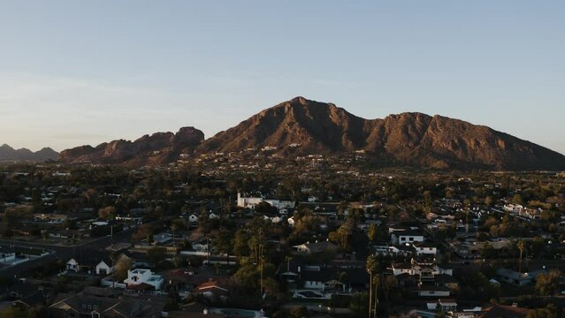 Wide aerial view of houses surrounding Camelback Mountain in Arizona.