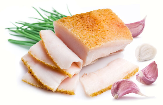 Salo slices or salt pork fatback slices with garlic and green onion isolated on white background.