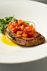 Baked sweet potato with fresh tomatoes