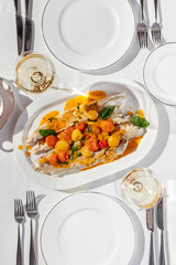 Baked trout and tomatoes in wine sauce