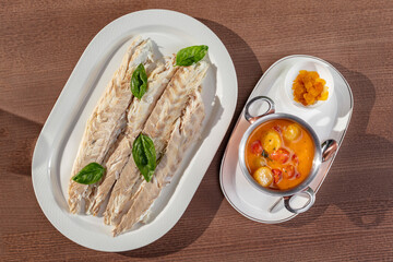 Baked trout and tomatoes in wine sauce