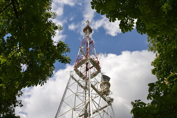 Weather station on blue sky and trees background. 