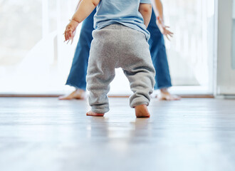 Taking his first steps on his own. Cropped shot of an unrecognizable little boy learning to walk...