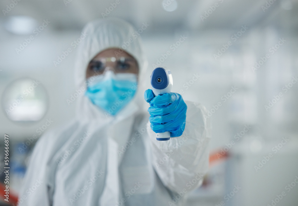 Poster i have to take your temperature. shot of a young scientist holding a thermometer at a lab.