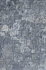 Greek letters stone background