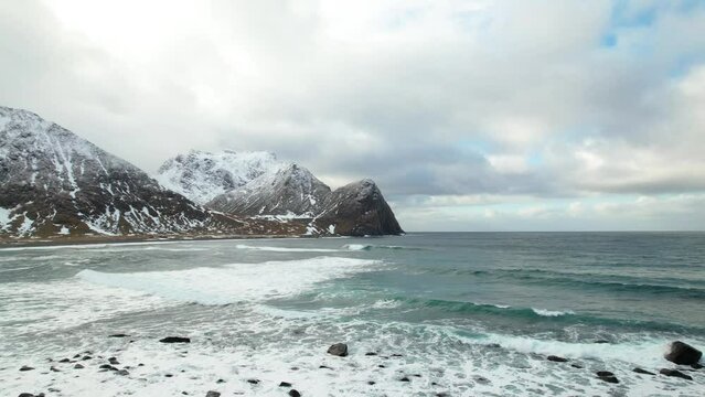 Aerial view of ocean waves snow-covered mountains, Lofoten Islands, Norway