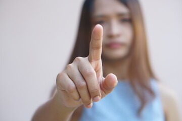 Woman pointing finger forward to press button