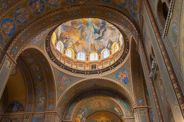 Fototapeta na wymiar The Szeged Votive Church, a place of Christian worship and spirituality, is adorned with stunning frescos and mural paintings that reflect its faith-based architecture. 