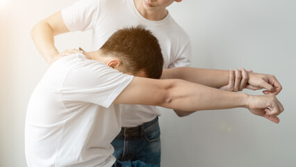 Fototapeta premium Therapist treating injured back of male patient.