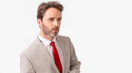 Handsome male model posing wearing a silver suit and a red tie.