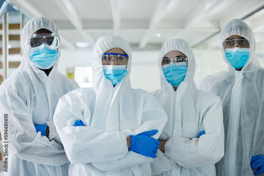 Poster were on the job. shot of a group of scientists standing with their arms crossed at a lab.