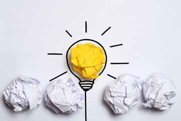 Creative thinking ideas and innovation concept. Paper scrap ball yellow colour with light bulb symbol