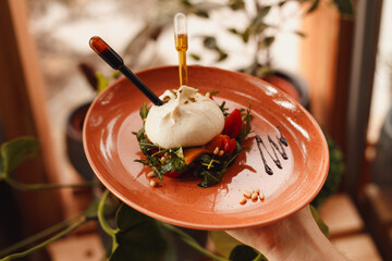 caprese salad with mozzarella inserted pipettes with olive oil and balsamic