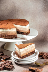 Layered Three Chocolate no baked cheesecake on a light background. vertical image. place for text
