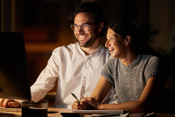 We figured this out pretty quickly. Shot of two businesspeople working together on a computer in an office at night.