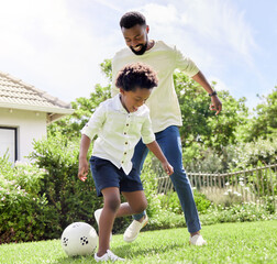 They have so much energy today. Shot of a father and son playing soccer together outdoors.