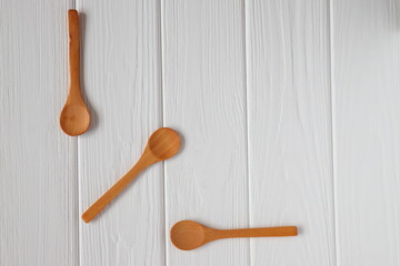 Wooden spoons mockup on white wood table, copy space