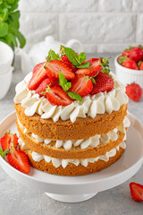 Strawberry cake, vanilla sponge cake with cream cheese and fresh strawberries. Summer cake. Selective focus.