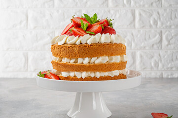 Strawberry cake, vanilla sponge cake with cream cheese and fresh strawberries. Summer cake. Selective focus.