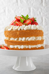 Strawberry cake, vanilla sponge cake with cream cheese and fresh strawberries. Summer cake. Selective focus.