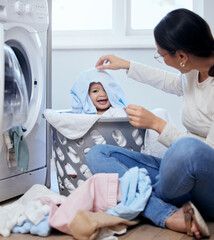 Can you see me mom. Shot of a young mother playfully bonding with her baby girl while doing the...