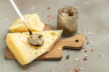 cheese with holes and mushrooms sauce, truffle paste on a black plate. banner, menu, recipe place for text, top view