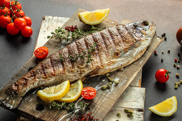grilled trout with lemon pieces, Food recipe background. Close up