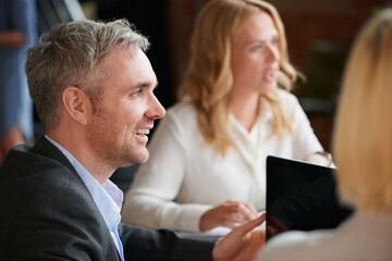 Hes excited to share his ideas too. Shot of a mature businessman having a meeting with his colleagues in an office.