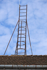 Metal ladder on the roof of a building